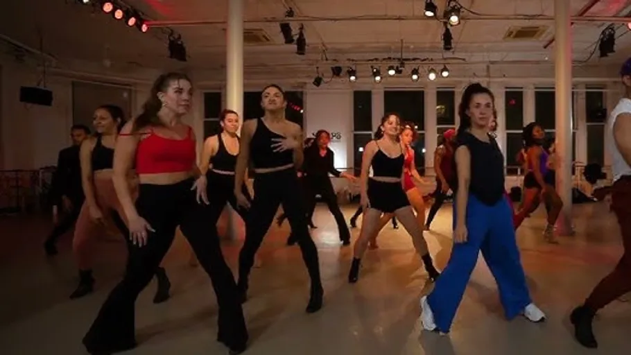 Group dancing energetically in a studio.