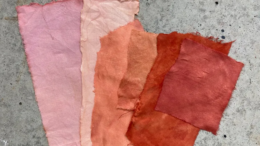 Colorful fabric swatches on a concrete surface.