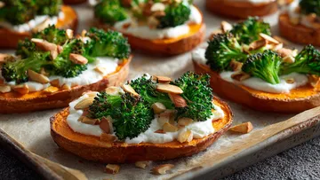 Sweet potato slices topped with broccoli and almonds.
