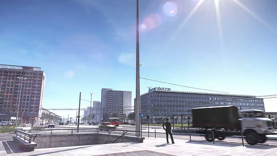Urban street scene with buildings and vehicles.