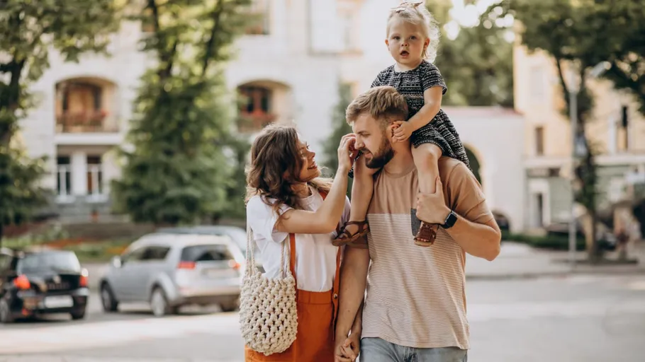 Family walking together in urban park.
