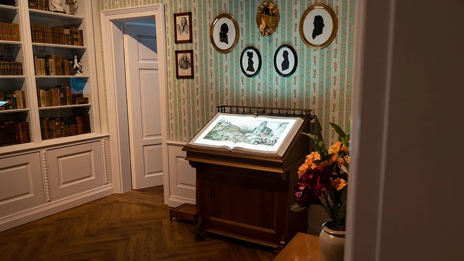 Illuminated book on stand in vintage room.
