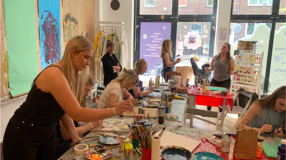 People painting together in a bright studio.