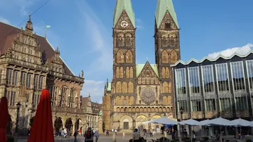 Cathedral with towers in city square.