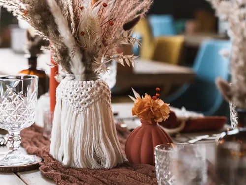 Vase with dried flowers on a festive table.