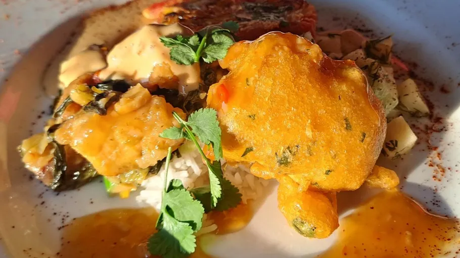 Fried seafood dish with herbs and sauce.