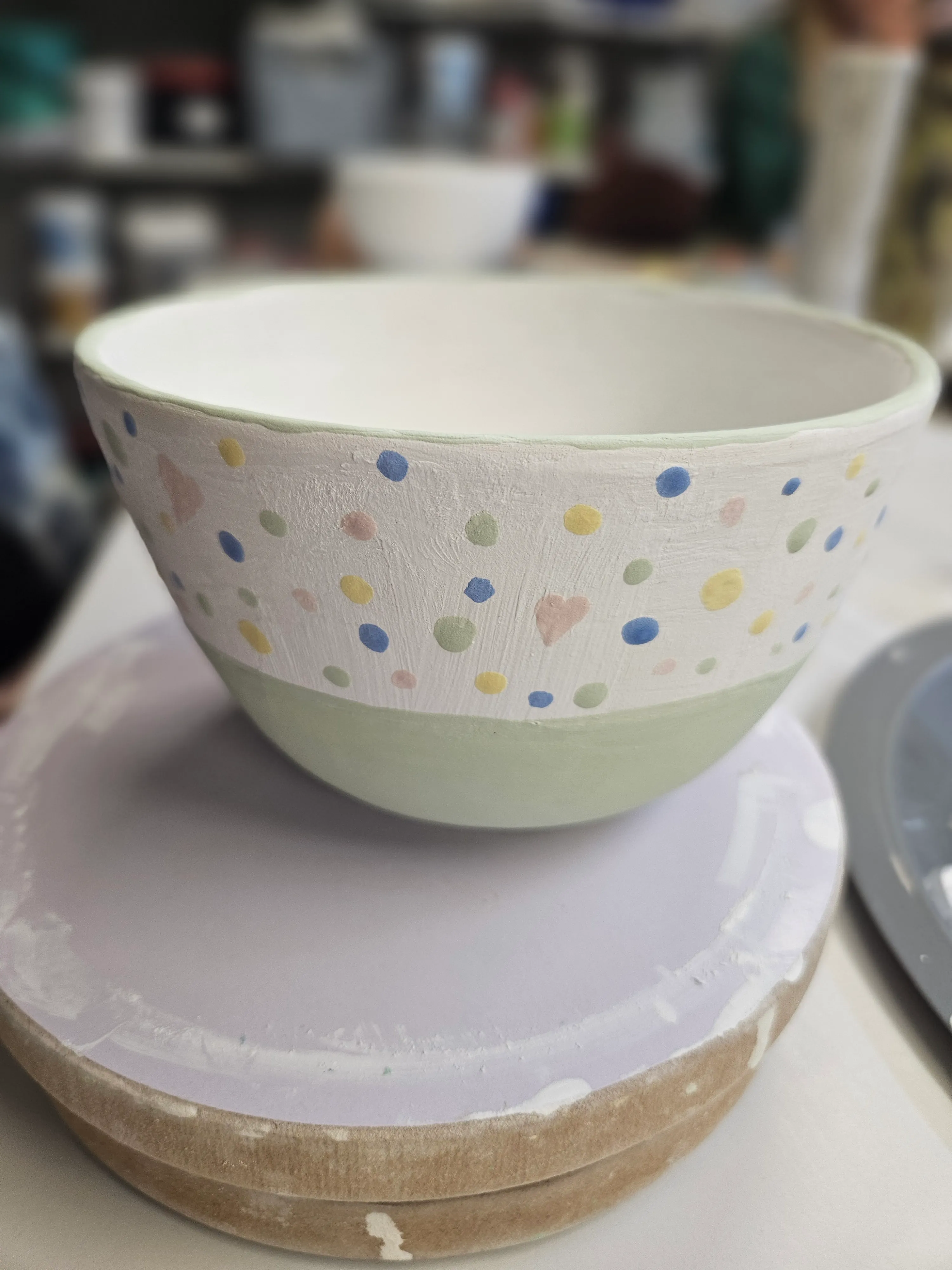 Painted ceramic bowl with colorful dots.