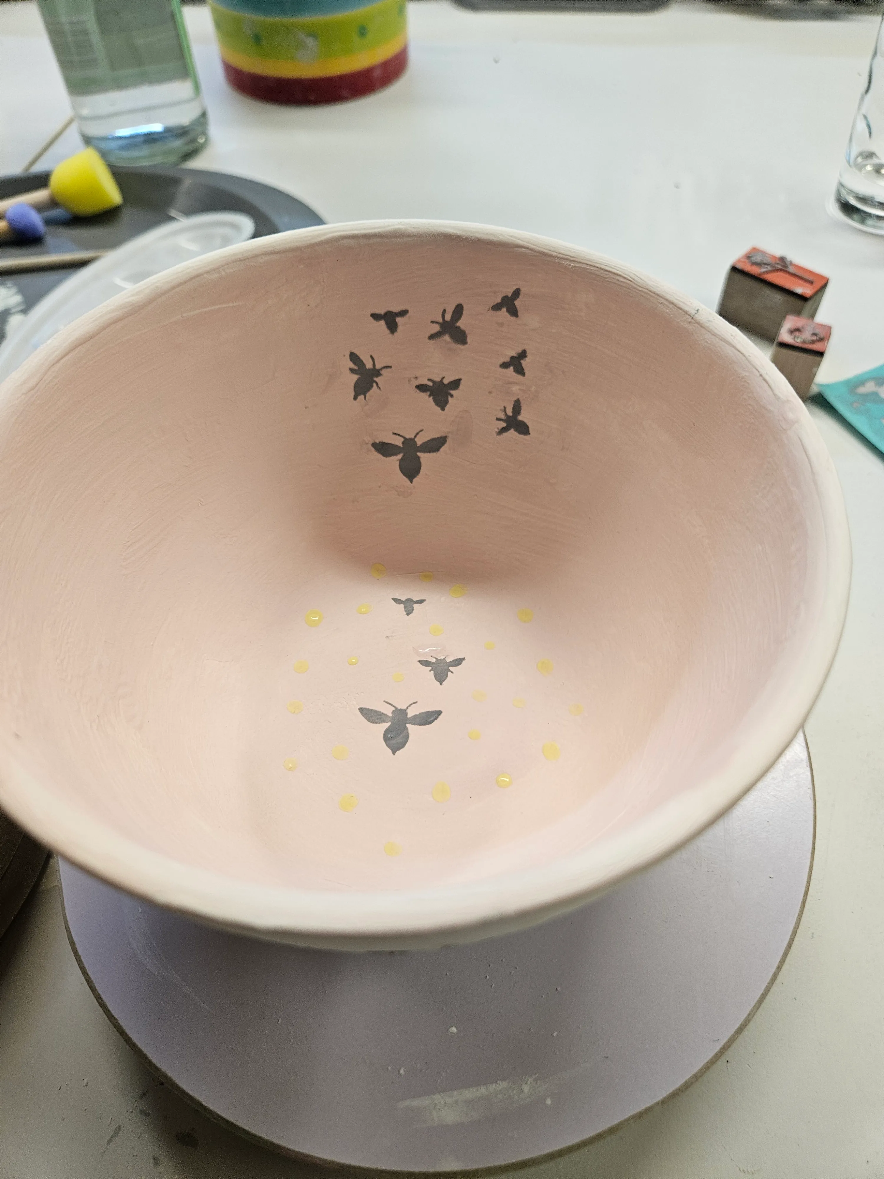 Bowl with bee design in pottery workshop.