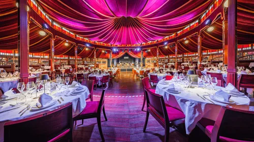 Elegant restaurant with purple draped ceiling.