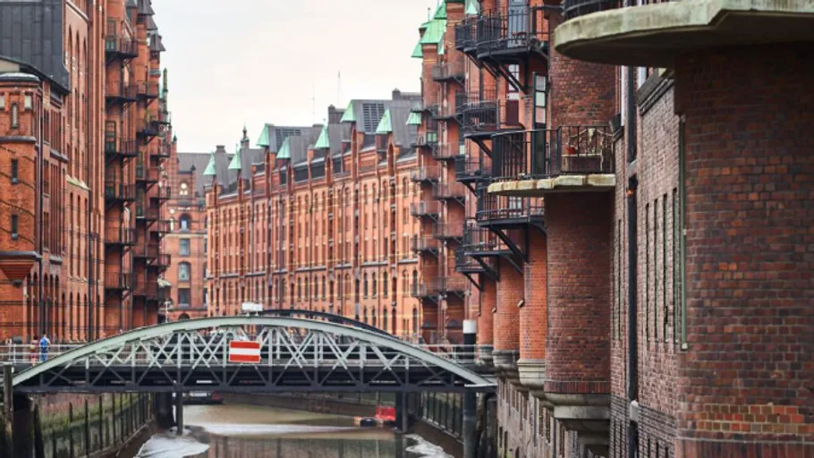 Red brick buildings and bridge over canal.