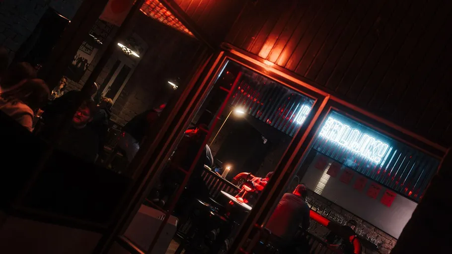 People socializing in a dimly lit bar.