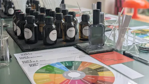 Perfume bottles and scent-testing tools on table.