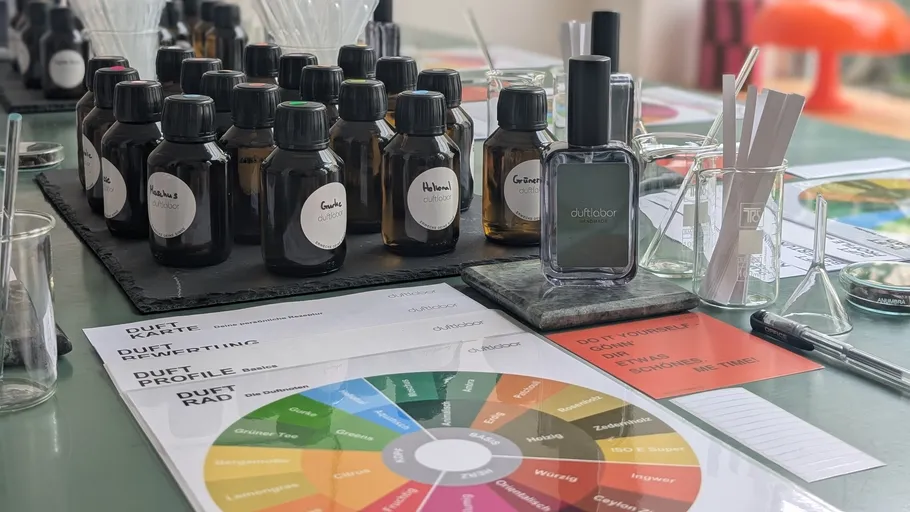 Perfume bottles and scent-testing tools on table.