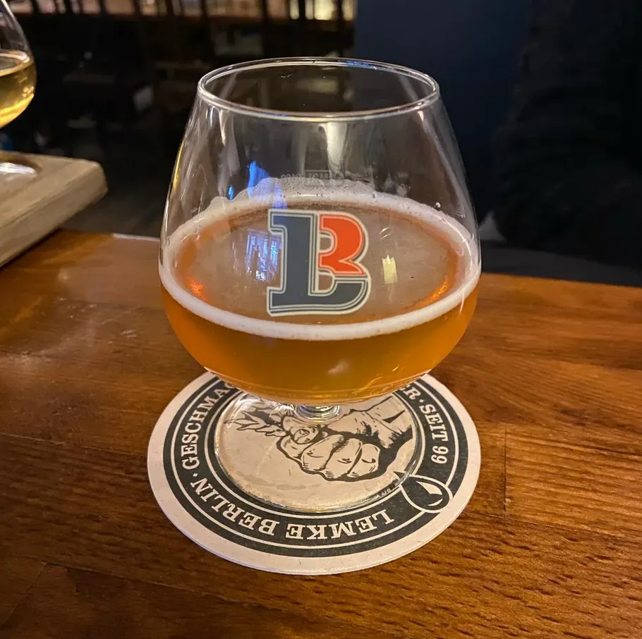 Glass of beer on a wooden table.