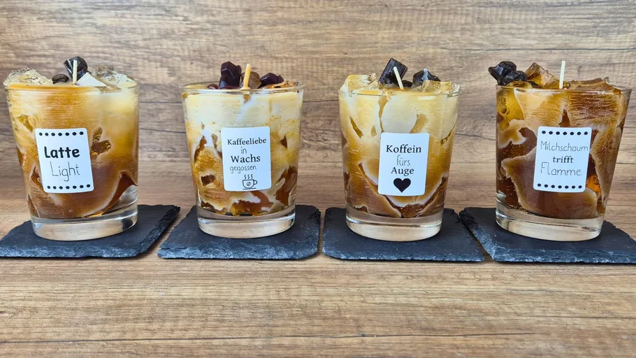Four decorative candles on slate coasters.