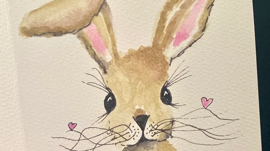 Watercolor rabbit drawing with pink hearts