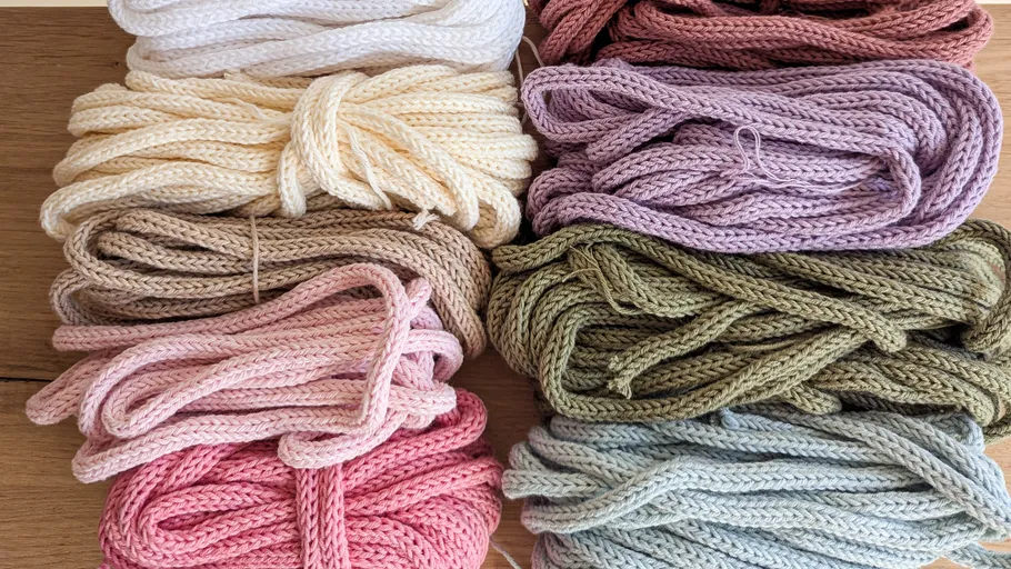 Colorful yarn bundles on wooden table.