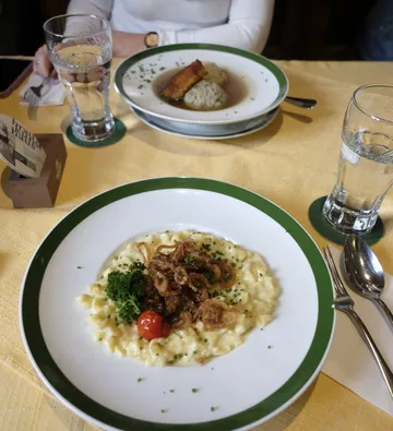 Plates with food on a restaurant table.