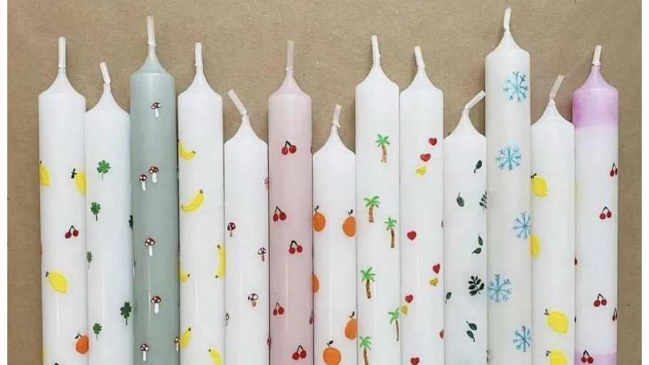 Colorful candles with various printed designs.