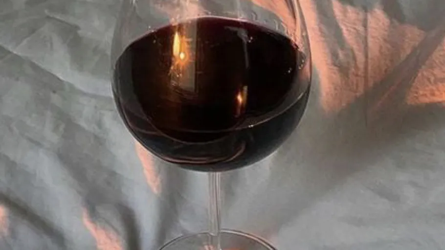 Glass of red wine on a tablecloth.