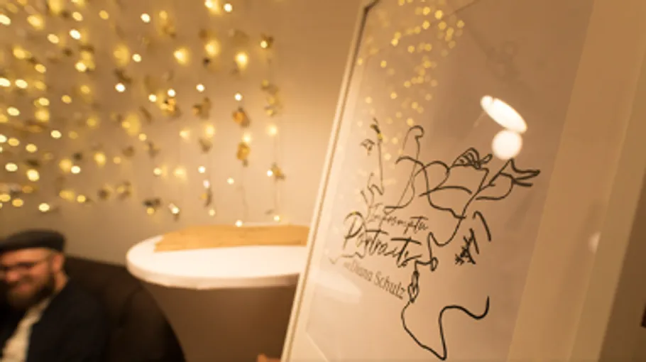 Blurred artwork near illuminated background wall.