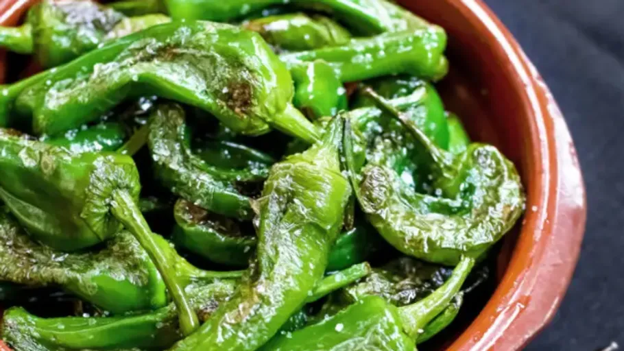 Green peppers in a brown bowl.