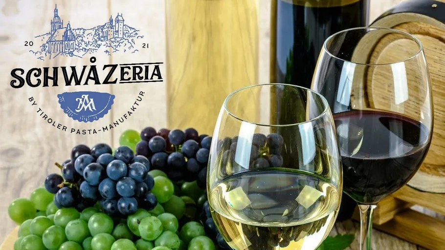 Wine glasses, grapes, bottle, and a barrel.