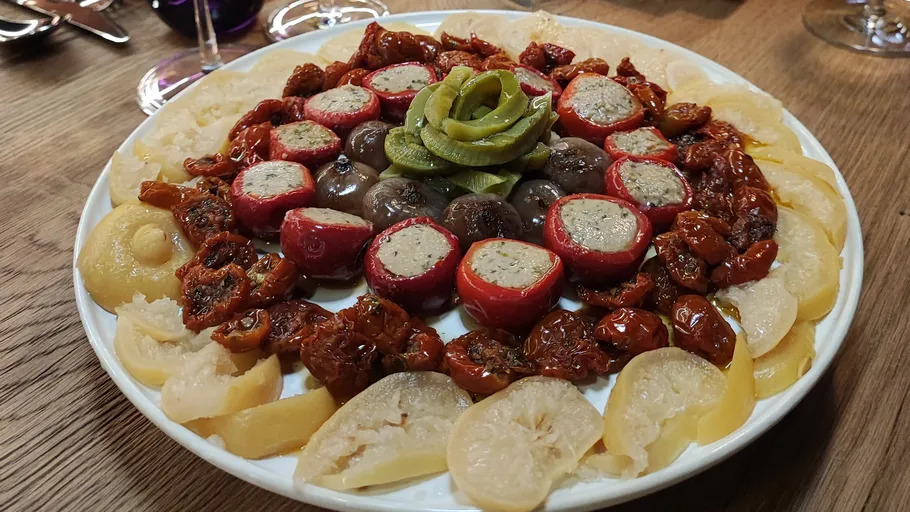 Plate with stuffed peppers, mushrooms, and pickles.
