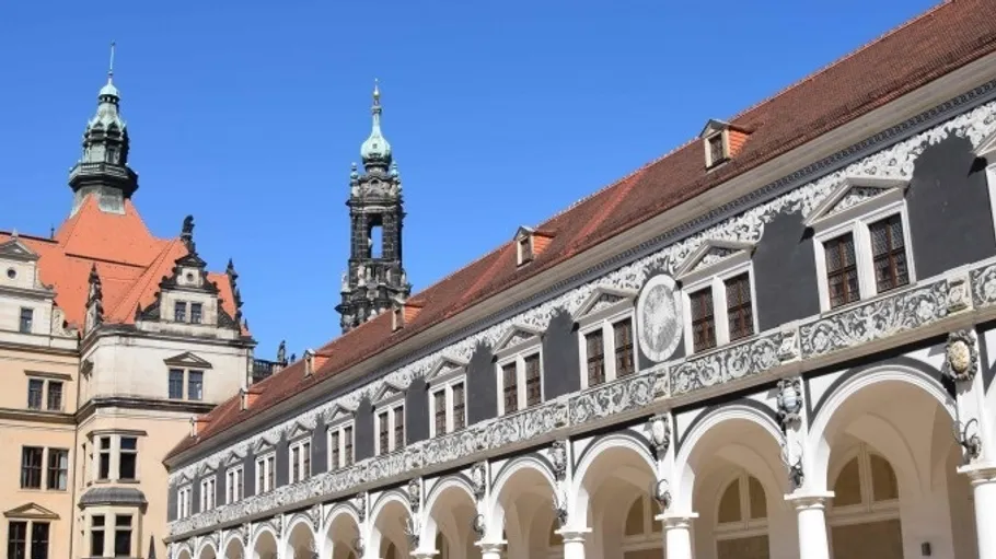 Ornate building with arches under blue sky.