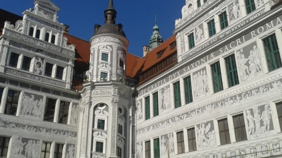 Historic building facade with ornate decorations, blue sky.
