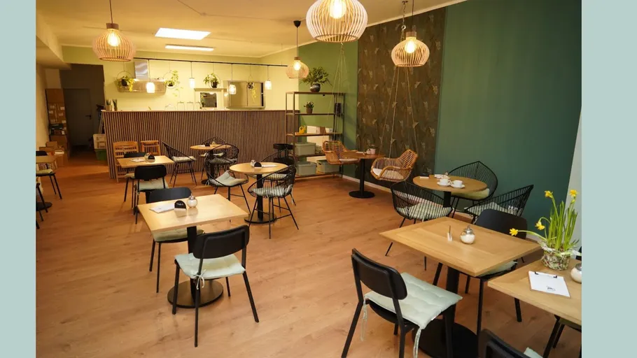 Empty modern cafe with wooden tables and chairs.