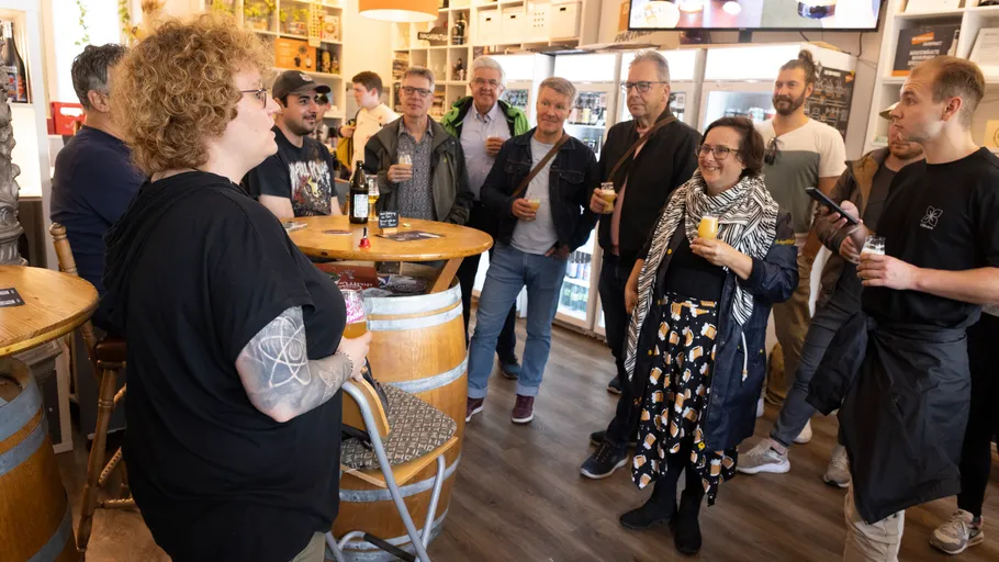 Group gathered around table in tasting room.