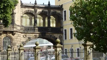 Historic bridge connecting old stone buildings.