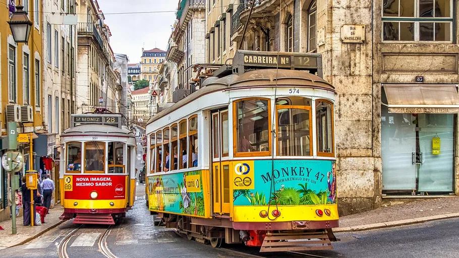 Two trams passing in narrow city street.