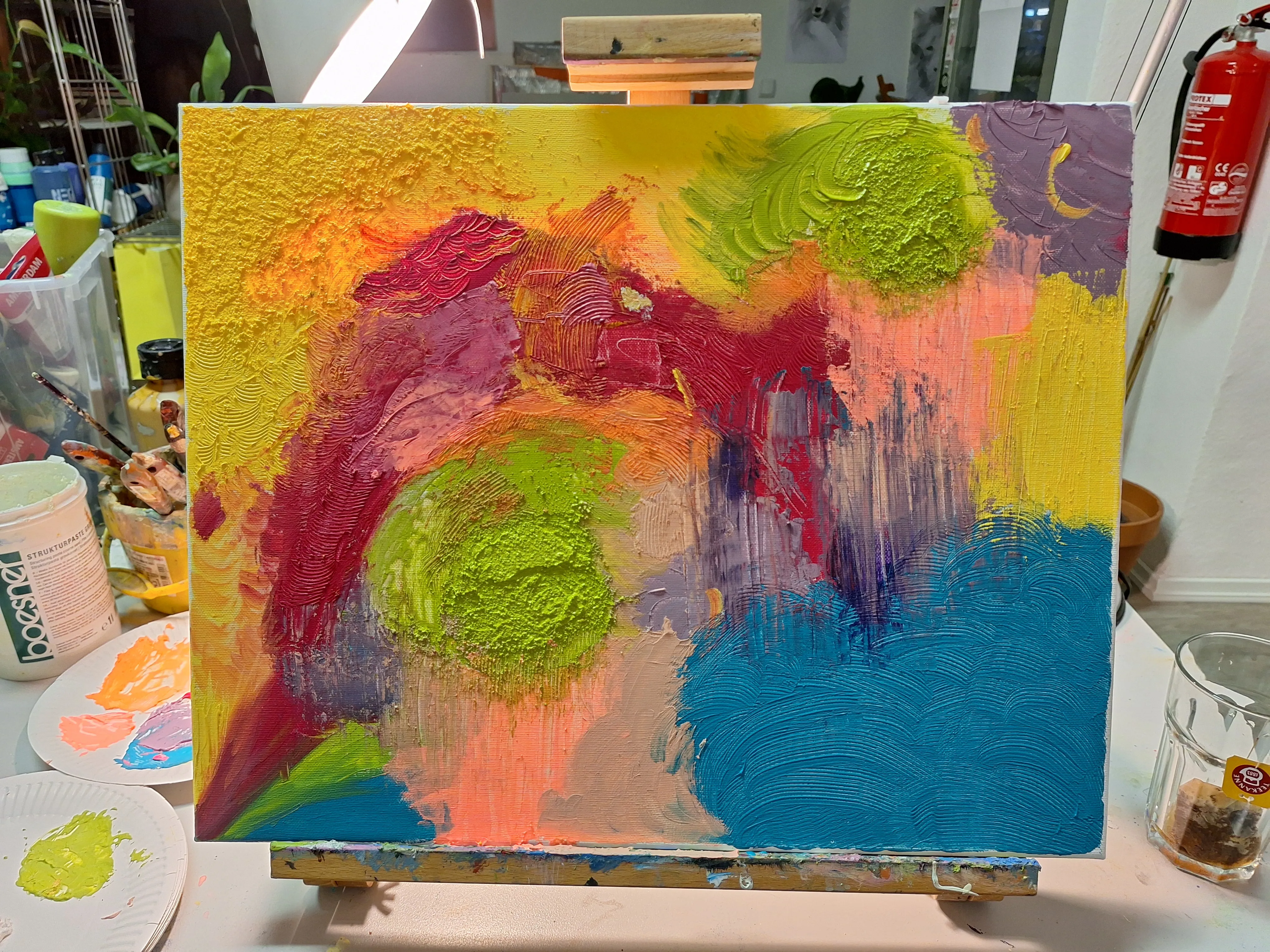 Colorful abstract painting on an easel.