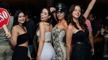 Four women posing at a nightclub.