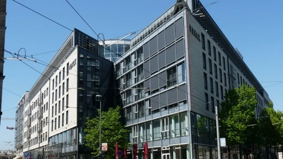 Modern office building under clear blue sky.