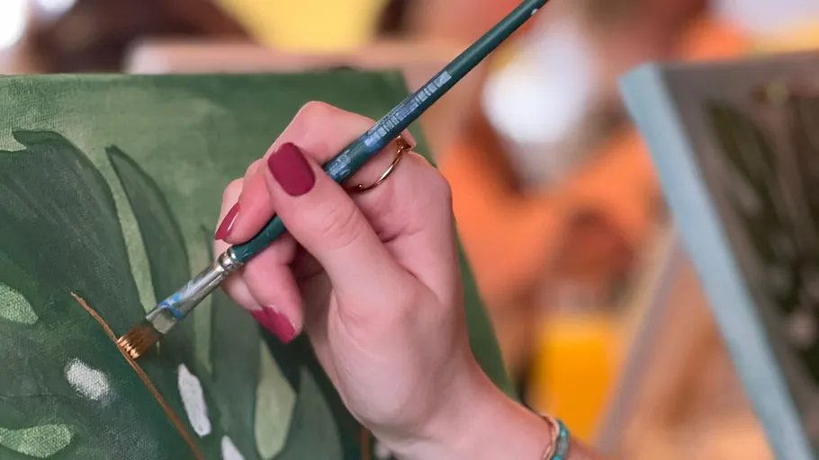 Hand painting on canvas, blurred background.