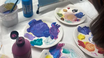 Painted paper plates on a table.