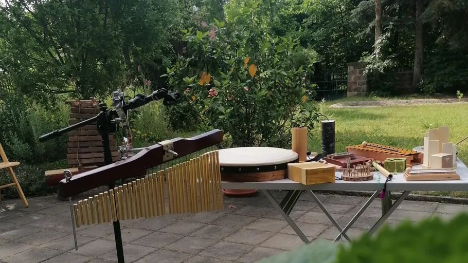 Schlaginstrumente auf Tisch im Garten.