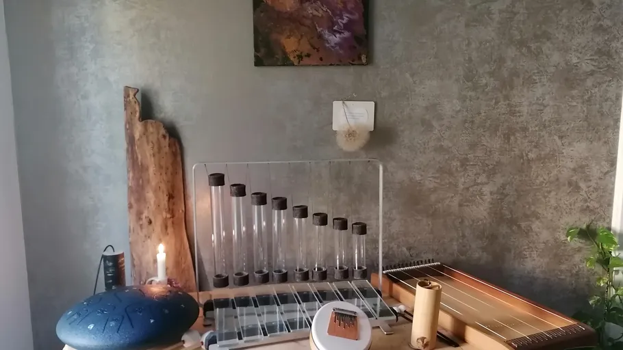 Assorted percussion instruments on a wooden table.