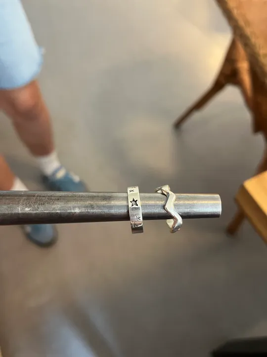 Metal rings on rod with leg visible.