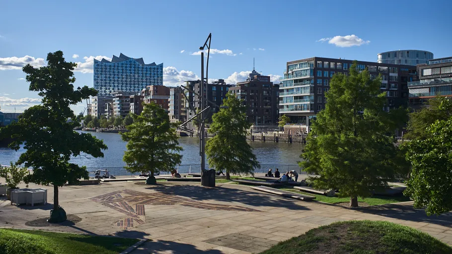 Modern buildings beside a riverside park.