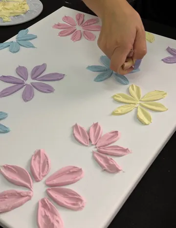 Hand painting colorful flowers on canvas.