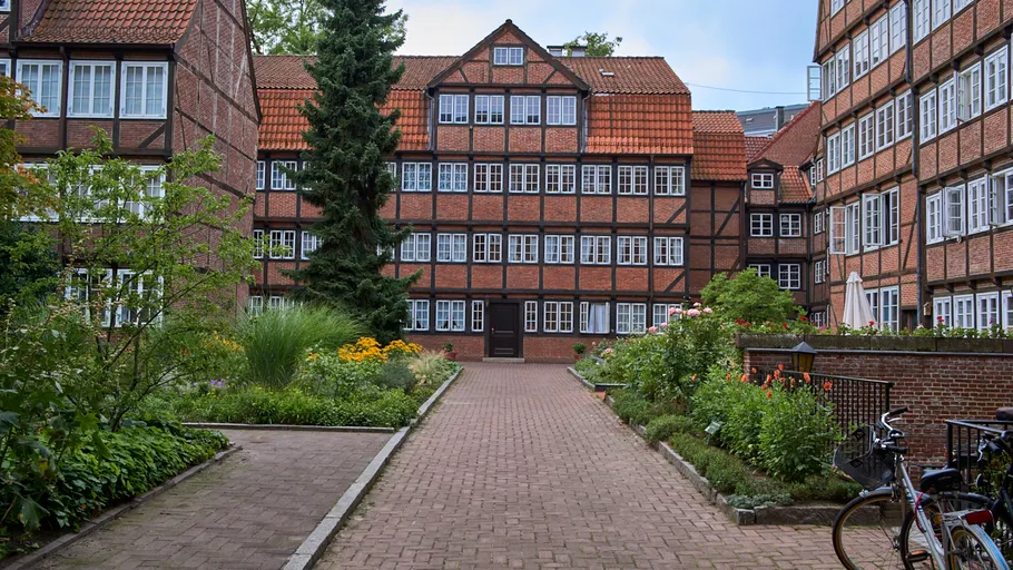 Historic brick building in a garden courtyard.