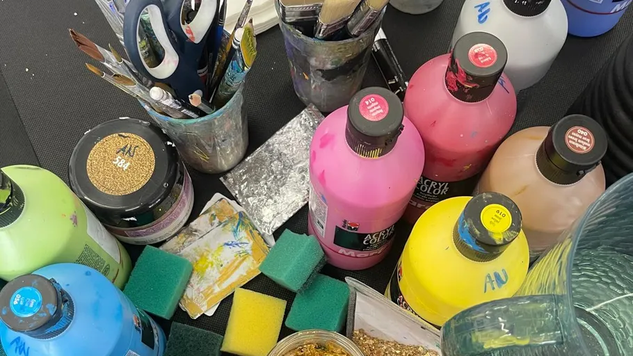 Painting supplies on a black table.