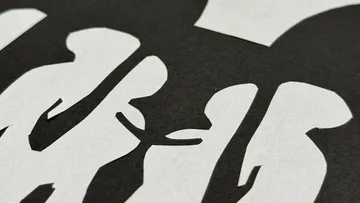 White paper cut-outs on black background.