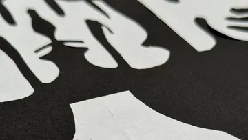Close-up of cut-out shapes on dark background.