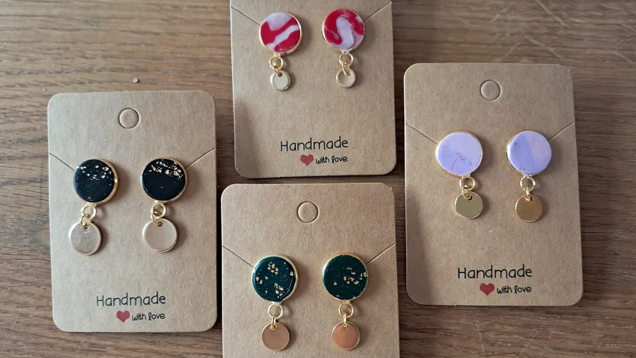 Five pairs of handmade earrings on cards.