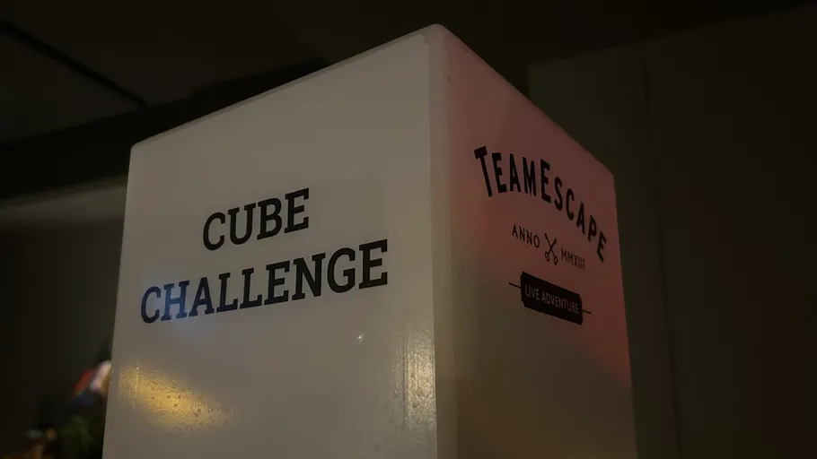 Cube with text inside a dim room.
